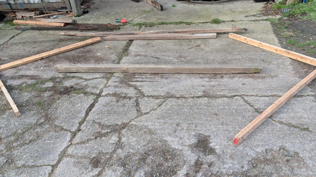 Finding the right wood from the pile.